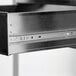 A close-up view of a stainless steel drawer on an equipment stand.