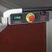 A red maple laminate and stainless steel electric portable bar with a control panel, emergency stop button, and digital display.