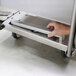 A stainless steel on-board drawbar being handled, designed for use with Lakeside utility carts.