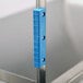 A blue plastic bumper attached to the corner of a metal utility cart.