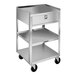 A stainless steel equipment stand with three shelves, a drawer, and casters.