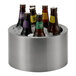 A brushed stainless steel party tub filled with ice and assorted bottled beverages.