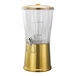 A round 3-gallon cold beverage dispenser with a metallic vintage gold base, clear Tritan plastic container, hands-free spigot, and an infuser tube inside.