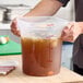 A translucent round 8-quart polypropylene food storage container with red measurement markings.