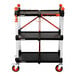 A three-shelf foldable jobsite cart with wheels and a black and orange color scheme.