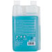 A 1-liter bottle of Urnex Rinza milk frother cleaner with blue liquid and dual measuring chambers.