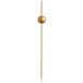 A bamboo cocktail pick with a gold ball decoration near the top.