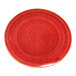 A red oval coupe porcelain steak plate with a speckled design.