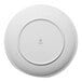 A round, white porcelain plate shown from the bottom with the Ariane brand logo at the center.
