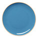 A blue round rimless coupe porcelain plate with a slightly speckled design.