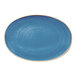 An oval blue porcelain plate with a slightly speckled design and a coupe edge.
