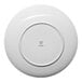 A round, warm white porcelain coupe flat plate viewed from the bottom, with the Ariane brand logo at the center.