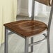 A wooden seat designed for use with metal frame chairs.