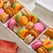 A rectangular tray filled with assorted colorful macarons from the Macaron Centrale Fall Macaron Variety Pack.