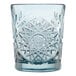 A blue glass tumbler with an intricate starburst pattern.