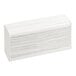 A stack of white multi-fold paper towels.