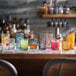 A set of colorful, patterned Libbey Hobstar 16 oz. Topaz cooler glasses displayed on a bar counter.
