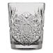 A clear glass tumbler with an intricate, starburst cut pattern design.