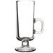 An 8 oz. clear glass Irish coffee mug with a handle and a pedestal base.