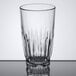 A clear 12 oz. beverage glass with a faceted design.