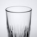 A clear 12 oz. beverage glass with a textured design.