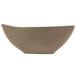 A matte sand-colored porcelain bowl with an organic, curved shape.