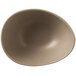 A sand-colored, matte-finish porcelain bowl with an organic, asymmetrical shape.