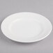 A white round porcelain plate with a wide rim.