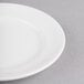 A white round porcelain plate with a wide rim.