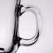 A close-up of the handle of a clear glass coffee mug.