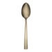 A gold-colored stainless steel teaspoon with a simple, modern design.