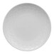 A white porcelain plate with a subtle geometric pattern around the rim.