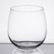 A clear, stemless red wine glass with a rounded bowl and a 16.75 oz. capacity.