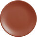A round, clay-colored satin matte porcelain coupe plate.