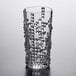 A clear glass with a geometric, textured pattern designed for serving long drinks or cocktails.