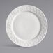 A white porcelain round plate with a wide, textured rim.