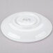 A white porcelain tea saucer shown upside down.
