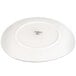 A white porcelain plate shown upside down with a manufacturer's mark at the center.
