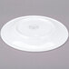 A white porcelain plate shown upside down on a gray background.