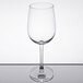 A clear, stemmed 16 oz. wine glass with a rounded bowl and flat base.