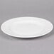 A white round porcelain plate with a wide rim.