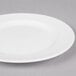 A white round porcelain plate with a wide rim.
