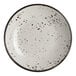 A round white melamine bowl with black speckled pattern and a dark rim.