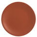 A round, clay-colored satin matte porcelain coupe plate.