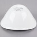 A small, bright white oval porcelain bowl turned upside down.