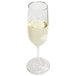A clear 6 oz. flute glass partially filled with a light-colored beverage.