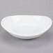A small, bright white oval porcelain bowl.