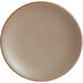 A round, sand-colored satin matte porcelain coupe plate.