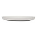 A white satin matte porcelain flat coupe plate with a minimalist design.