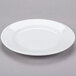 A plain white porcelain plate with a slightly raised rim.